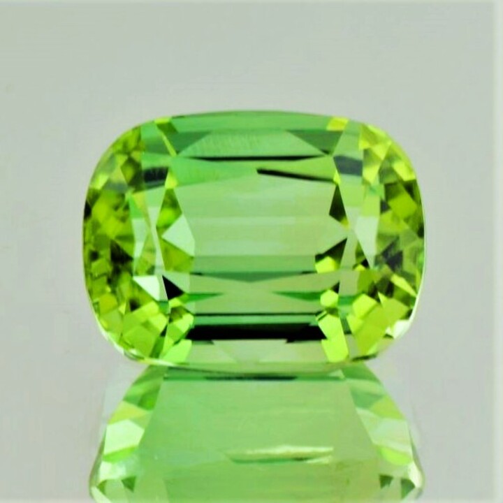 Tourmaline cushion yellowish light green 21.82 ct.